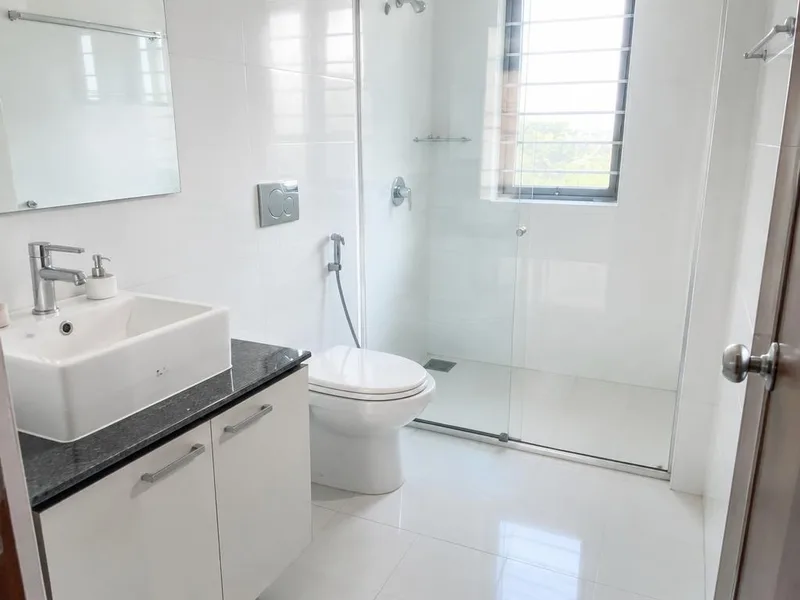 Bright modern bathroom washroom with glass partition and wall tiles